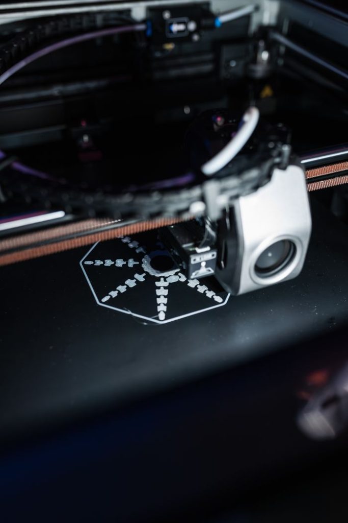 pexels photo 20877035 Detailed view of a 3D printer creating a precise object, showcasing advanced technology.
